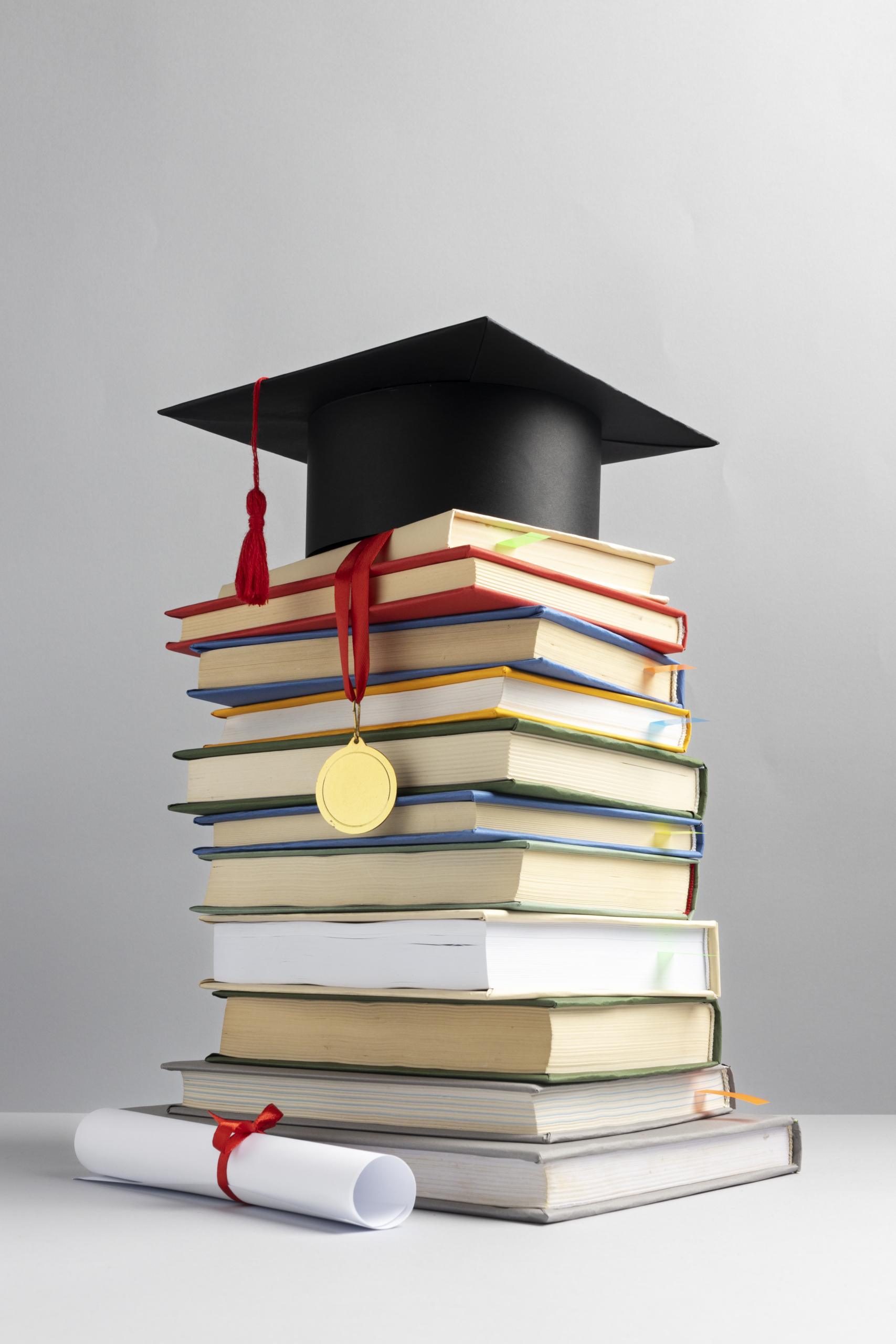 front-view-stacked-books-graduation-cap-diploma-education-day